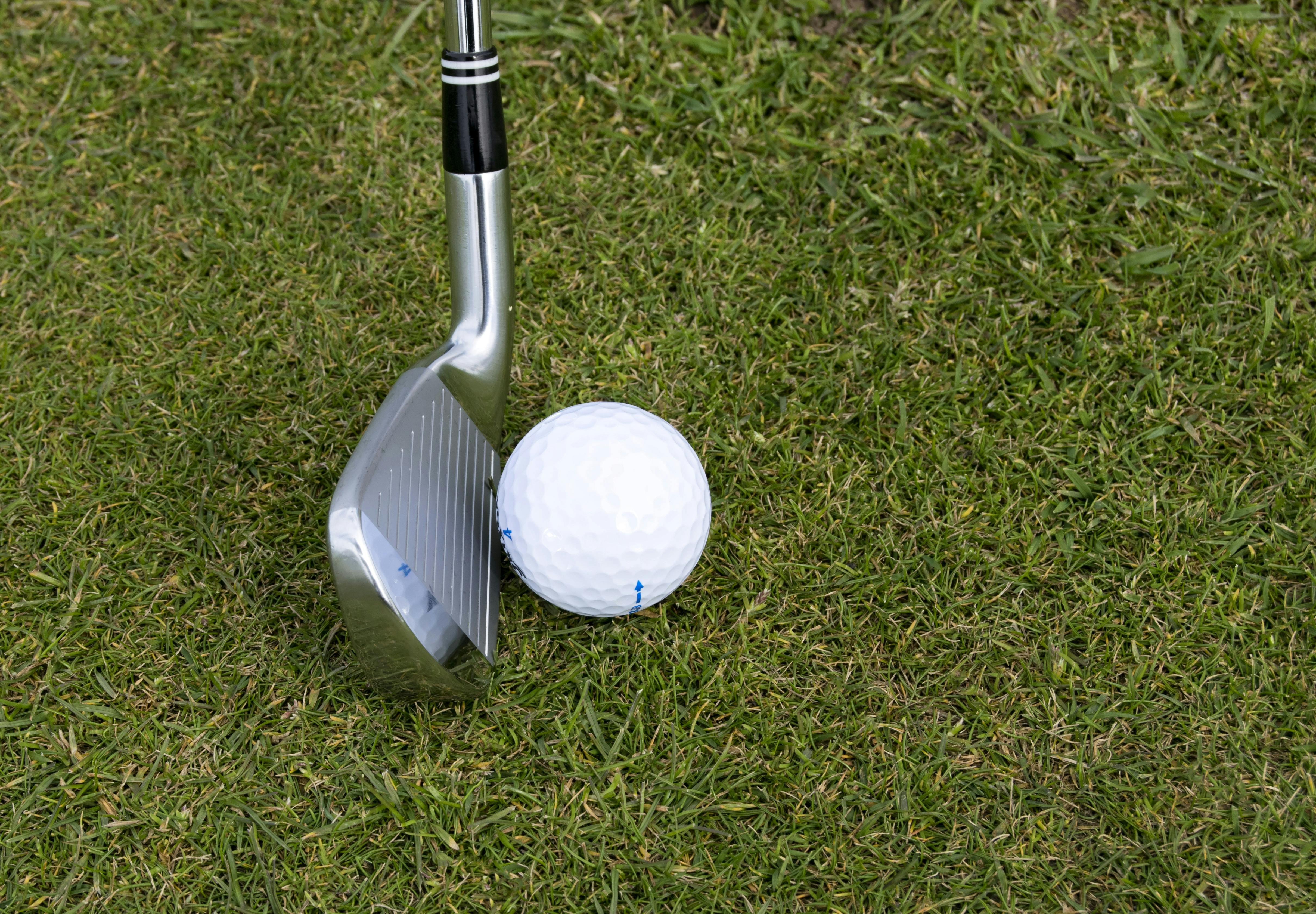 putt near golf ball